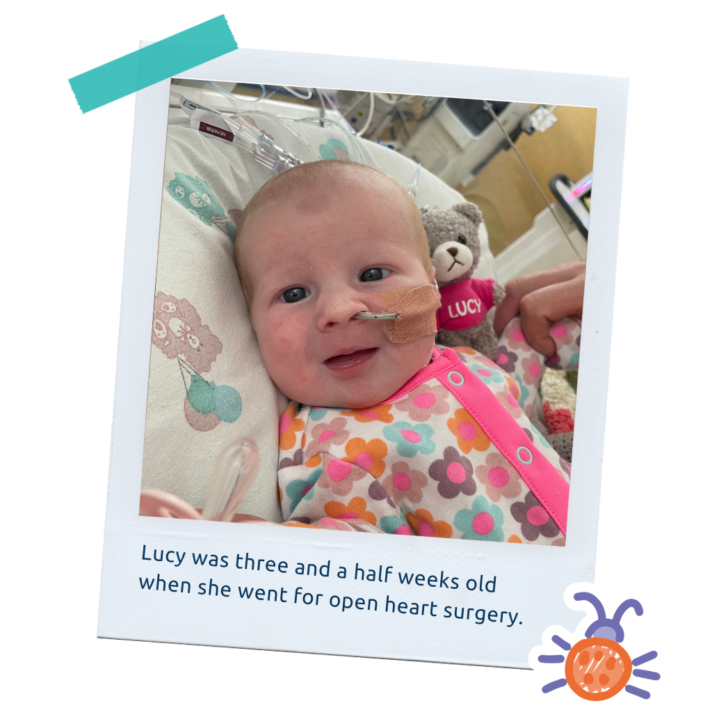 Lucy_LP_Thum6: "A polaroid-style photo of baby Lucy smiling, captioned about her open heart surgery at three and a half weeks old."