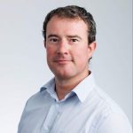 Alex-1: "Professional headshot of Alex, a man in a light blue shirt."