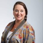 Alfreda-1: "Professional headshot of Alfreda, a smiling woman in a patterned top."